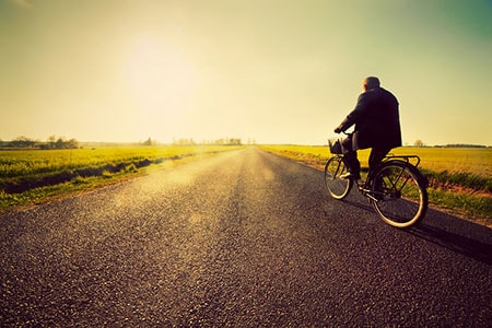 Biker on Long Road Riding to Success